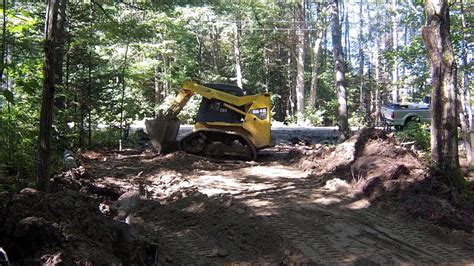 Spreading stone with a skid steer 